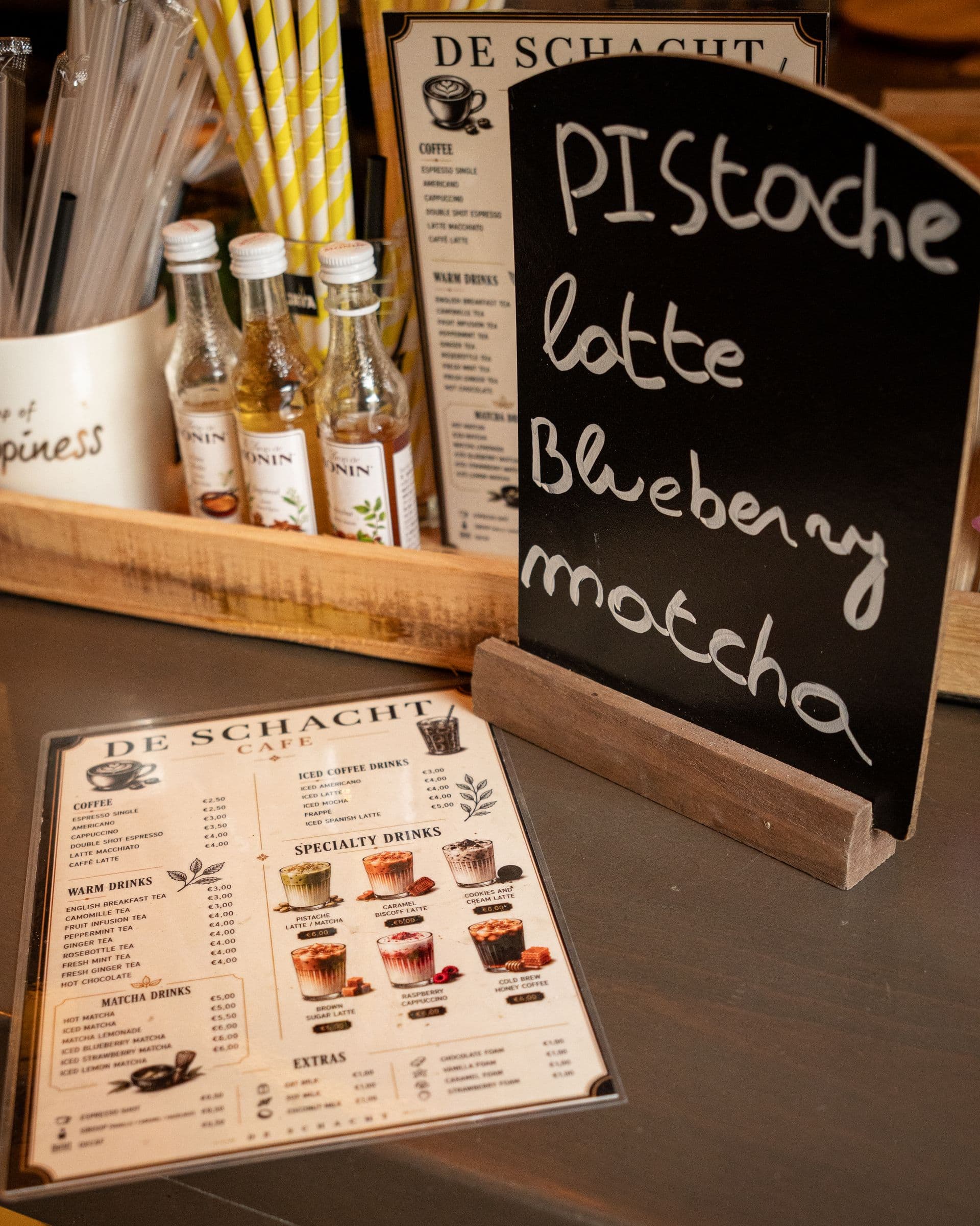 The counter with the menu card and a chalkboard of the day’s lattes and matcha.